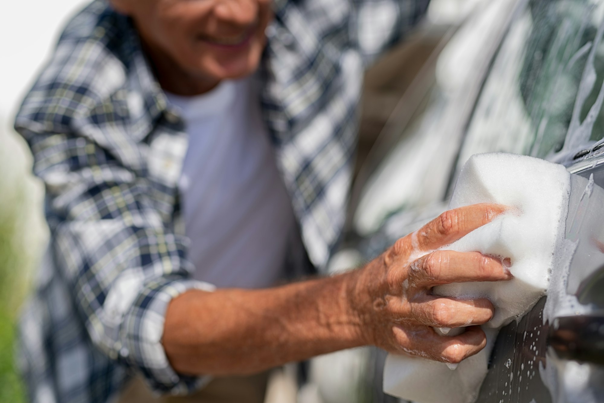 Closeup of man hand washing car