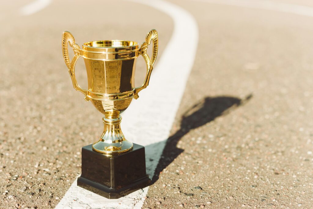 Gold prize cup for winner of competition at athletics stadium.